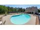 Community pool with lounge seating, bathhouse and tennis courts in the background on a sunny day at 6450 Oak Valley Dr, Cumming, GA 30040