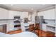 This spacious kitchen features stainless steel appliances, white cabinets, and a center island at 6450 Oak Valley Dr, Cumming, GA 30040