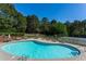 Community pool and tennis court surrounded by mature trees in a peaceful setting at 6450 Oak Valley Dr, Cumming, GA 30040