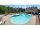 Community pool with lounge chairs and tables by the pool, with a tennis court nearby at 6450 Oak Valley Dr, Cumming, GA 30040