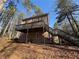 View of the backyard with wooden deck and staircase leading to the yard at 1007 Burton Nw Ct, Kennesaw, GA 30152