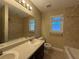 Bright bathroom featuring a double sink vanity and tiled shower-tub combination at 1007 Burton Nw Ct, Kennesaw, GA 30152