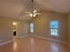 Spacious bedroom with vaulted ceiling, wood floors, and natural light from two windows at 1007 Burton Nw Ct, Kennesaw, GA 30152