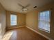 Serene bedroom with natural light, ceiling fan, and hardwood floors at 1007 Burton Nw Ct, Kennesaw, GA 30152