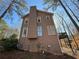 Rear exterior of home with deck, steps, and wooded surroundings at 1007 Burton Nw Ct, Kennesaw, GA 30152