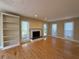 Bright living room featuring hardwood floors, a fireplace, and custom built-in shelving at 1007 Burton Nw Ct, Kennesaw, GA 30152