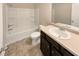 This well-lit bathroom offers a vanity with storage and a shower-tub combination at 1181 Paramount Dr, Mcdonough, GA 30253