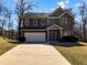 Two-story home with brick facade, attached garage, and concrete driveway at 1181 Paramount Dr, Mcdonough, GA 30253