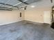 Large garage space with concrete flooring, a water heater, and door to the home at 1181 Paramount Dr, Mcdonough, GA 30253