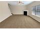 Spacious carpeted living room with fireplace, lots of light, and staircase at 1181 Paramount Dr, Mcdonough, GA 30253