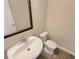 Cozy powder room featuring a stylish pedestal sink and modern toilet at 1181 Paramount Dr, Mcdonough, GA 30253