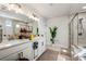 Bright bathroom showcasing double sinks, a large mirror, and a glass-enclosed shower at 236 Himalaya Way Way, Mcdonough, GA 30253