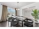 Elegant dining room features modern decor, dark hardwood floors, and a stylish chandelier at 236 Himalaya Way Way, Mcdonough, GA 30253