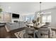 Open-concept dining area with a modern table and view of the living room fireplace at 236 Himalaya Way Way, Mcdonough, GA 30253