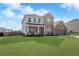 Charming two-story brick home featuring a manicured lawn and an attached two-car garage at 236 Himalaya Way Way, Mcdonough, GA 30253