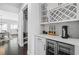 Bright kitchen featuring white cabinetry, wine rack, mini fridge, beverage station, and dark hardwood floors at 236 Himalaya Way Way, Mcdonough, GA 30253