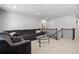 Living room with dark corduroy sectional, carpet, staircase, and a glass coffee table at 236 Himalaya Way Way, Mcdonough, GA 30253