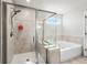 Modern bathroom with glass-enclosed shower and separate soaking tub at 236 Himalaya Way Way, Mcdonough, GA 30253