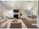 Staged living room with fireplace, plush rug, dining table, and plenty of natural light at 2721 Arctic Ct, Morrow, GA 30260