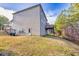 Spacious backyard with a view of the home's exterior, a small deck, and surrounding greenery at 847 Sand Ln, Lawrenceville, GA 30045