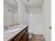 Well-lit bathroom with a shower-tub combo, granite countertop, and dark wood cabinetry at 847 Sand Ln, Lawrenceville, GA 30045