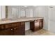 Bathroom featuring double sinks, granite countertops, and dark wood cabinetry at 847 Sand Ln, Lawrenceville, GA 30045