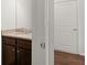 Powder room featuring a granite countertop, dark wood cabinets, and a chrome faucet at 847 Sand Ln, Lawrenceville, GA 30045