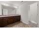 Modern bathroom featuring a double vanity with granite countertops and updated lighting fixtures at 847 Sand Ln, Lawrenceville, GA 30045