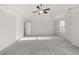 Large bedroom with a ceiling fan, two closets, and neutral walls and carpets at 847 Sand Ln, Lawrenceville, GA 30045