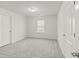 Bedroom with a view from a window, neutral walls, and gray carpet at 847 Sand Ln, Lawrenceville, GA 30045