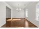 Bright dining room with hardwood floors, a chandelier, and large windows offering natural light at 847 Sand Ln, Lawrenceville, GA 30045