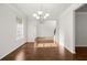 Open dining room with hardwood floors, a modern chandelier, and windows for natural light at 847 Sand Ln, Lawrenceville, GA 30045