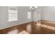 Elegant dining room featuring hardwood floors, chandelier, and windows for abundant natural light at 847 Sand Ln, Lawrenceville, GA 30045