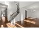 Inviting entryway with gleaming hardwood floors, a staircase with iron railing, and bright, neutral walls at 847 Sand Ln, Lawrenceville, GA 30045