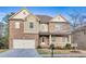 Beautiful two-story brick home with a well-manicured lawn, covered porch, and attached two-car garage at 847 Sand Ln, Lawrenceville, GA 30045