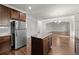 Modern kitchen featuring an island, stainless steel refrigerator, and stylish dark wood cabinetry at 847 Sand Ln, Lawrenceville, GA 30045