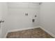 Neat laundry room space with hookups and modern tile flooring at 847 Sand Ln, Lawrenceville, GA 30045