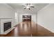 Bright living room with fireplace and open flow to kitchen featuring modern fixtures at 847 Sand Ln, Lawrenceville, GA 30045