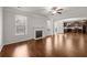 Open living room with hardwood floors, fireplace, and views of the kitchen at 847 Sand Ln, Lawrenceville, GA 30045