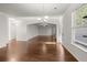 Sunlit living room with hardwood floors leading to connected rooms and outdoor access at 847 Sand Ln, Lawrenceville, GA 30045