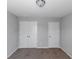 Neutral bedroom featuring wall-to-wall carpeting, standard ceiling fan, and double door closet at 1077 Roanoke Ave, Mcdonough, GA 30253