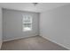 Neutral bedroom featuring wall-to-wall carpeting, natural light, and a standard ceiling fan at 1077 Roanoke Ave, Mcdonough, GA 30253