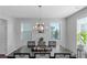Elegantly decorated dining room with dark wood table, chandelier lighting, and natural light, perfect for Gathering gatherings at 1077 Roanoke Ave, Mcdonough, GA 30253