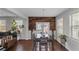 Dining room features decorative wood wall accent, modern light fixture, and large windows at 1077 Roanoke Ave, Mcdonough, GA 30253