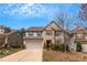 Charming two-story home with a manicured lawn, attached garage, and a combination of stone and siding at 1077 Roanoke Ave, Mcdonough, GA 30253