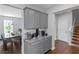 Kitchen nook features upper and lower gray cabinets, granite countertops and a view of dining area at 1077 Roanoke Ave, Mcdonough, GA 30253