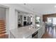 Modern kitchen with granite countertops, stainless steel appliances, and an open floor plan leading to the living area at 1077 Roanoke Ave, Mcdonough, GA 30253