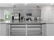 Modern kitchen with stainless steel appliances, gray cabinetry, and open shelving at 1077 Roanoke Ave, Mcdonough, GA 30253