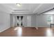 Open-concept living room featuring hardwood floors, neutral walls, recessed lighting, and privacy curtains at 1077 Roanoke Ave, Mcdonough, GA 30253