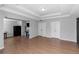 Open-concept living room featuring hardwood flooring, neutral walls, recessed lighting, and white doors at 1077 Roanoke Ave, Mcdonough, GA 30253